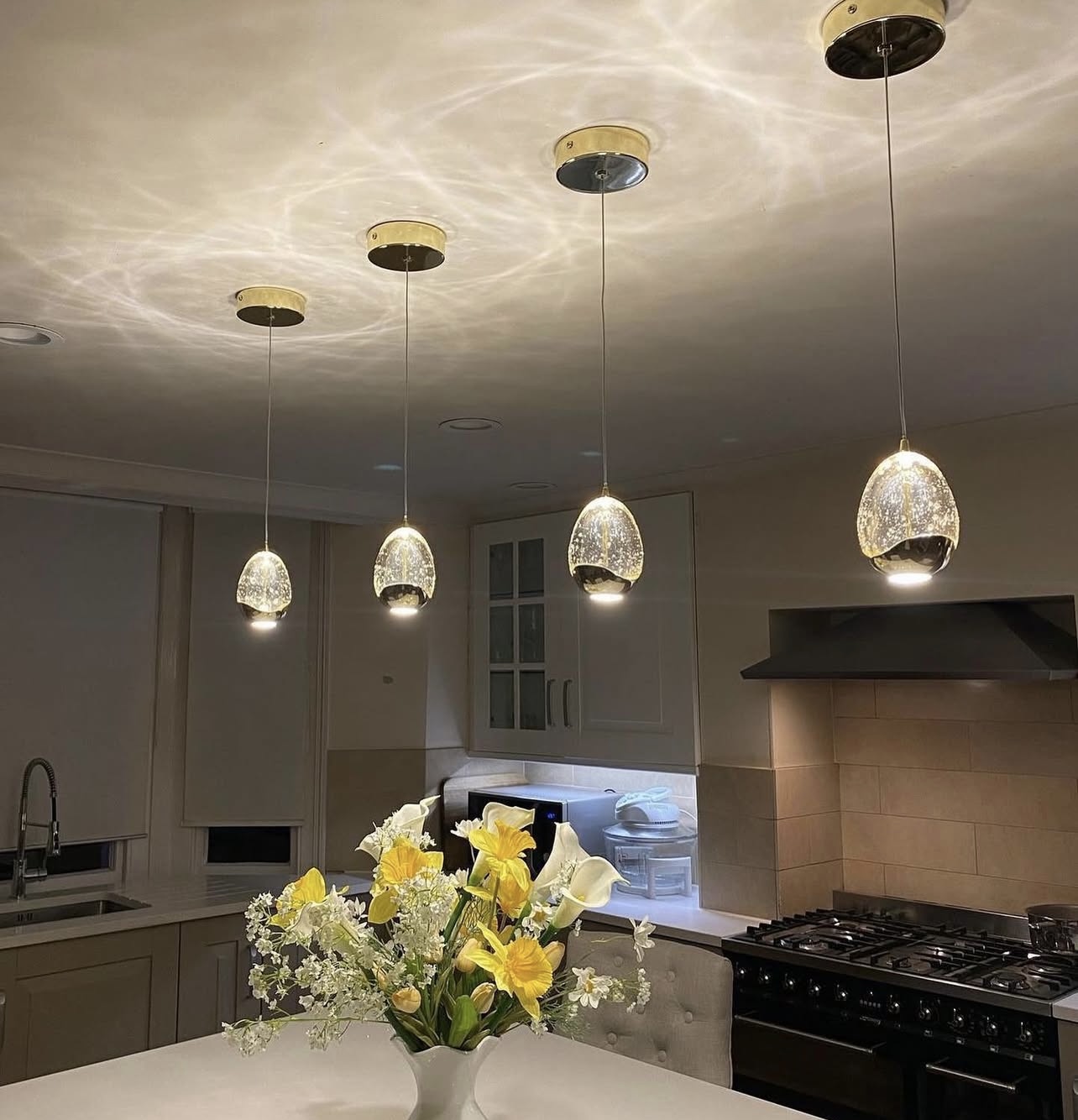 Glass pendant lights installed over a kitchen island