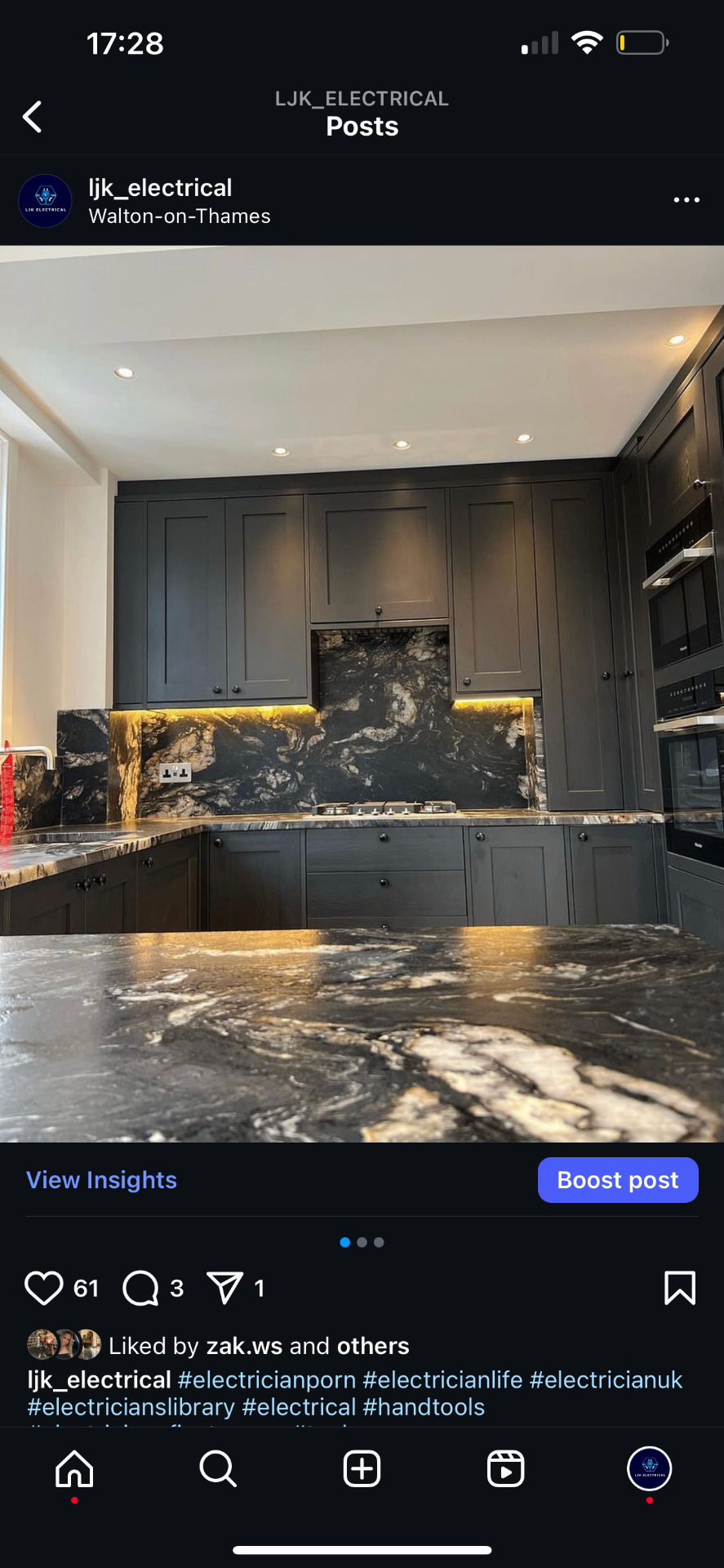 Dark luxury kitchen with LED under-cabinet lighting and gas hob