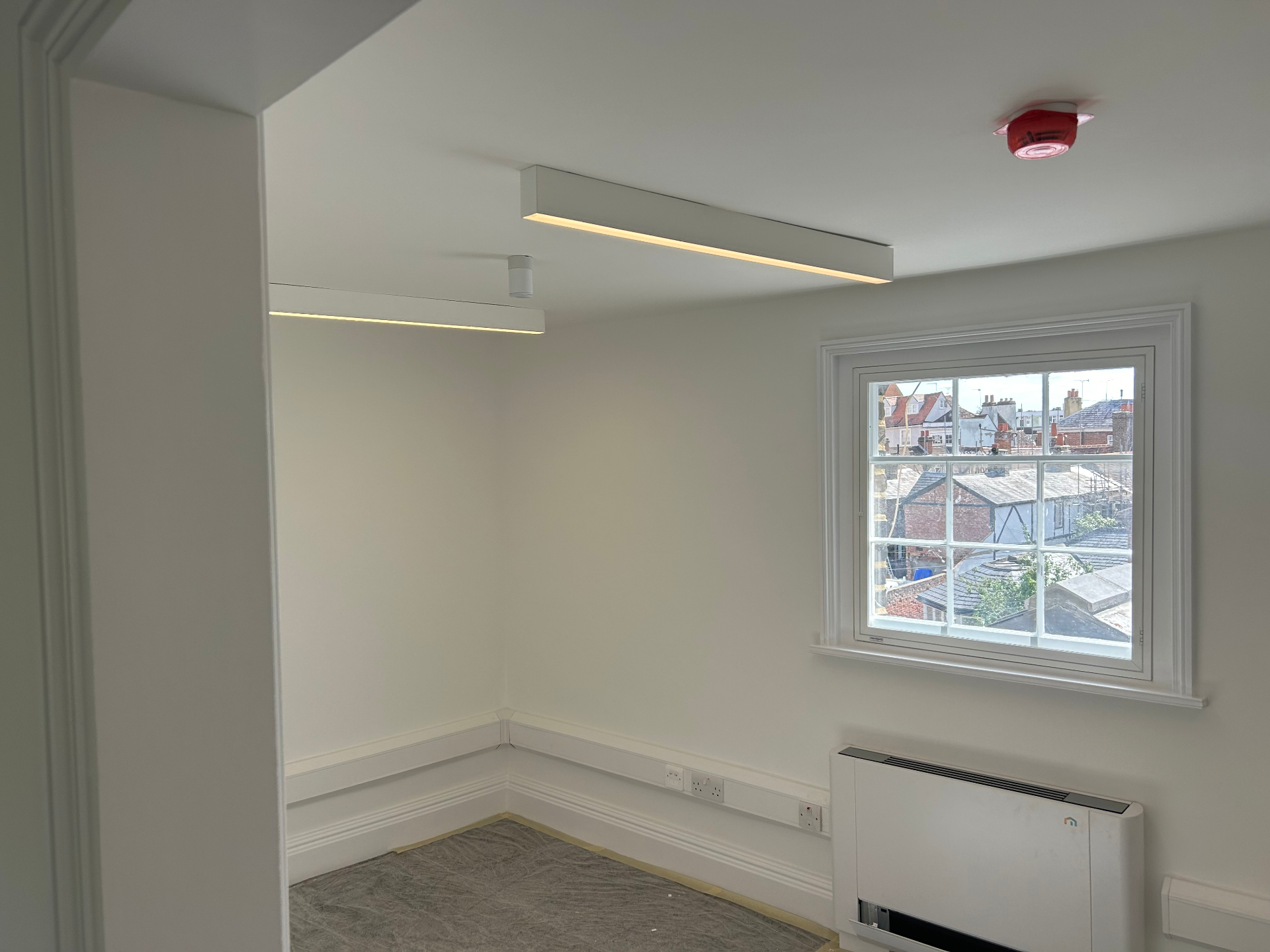 Linear LED light fitting installed on ceiling
