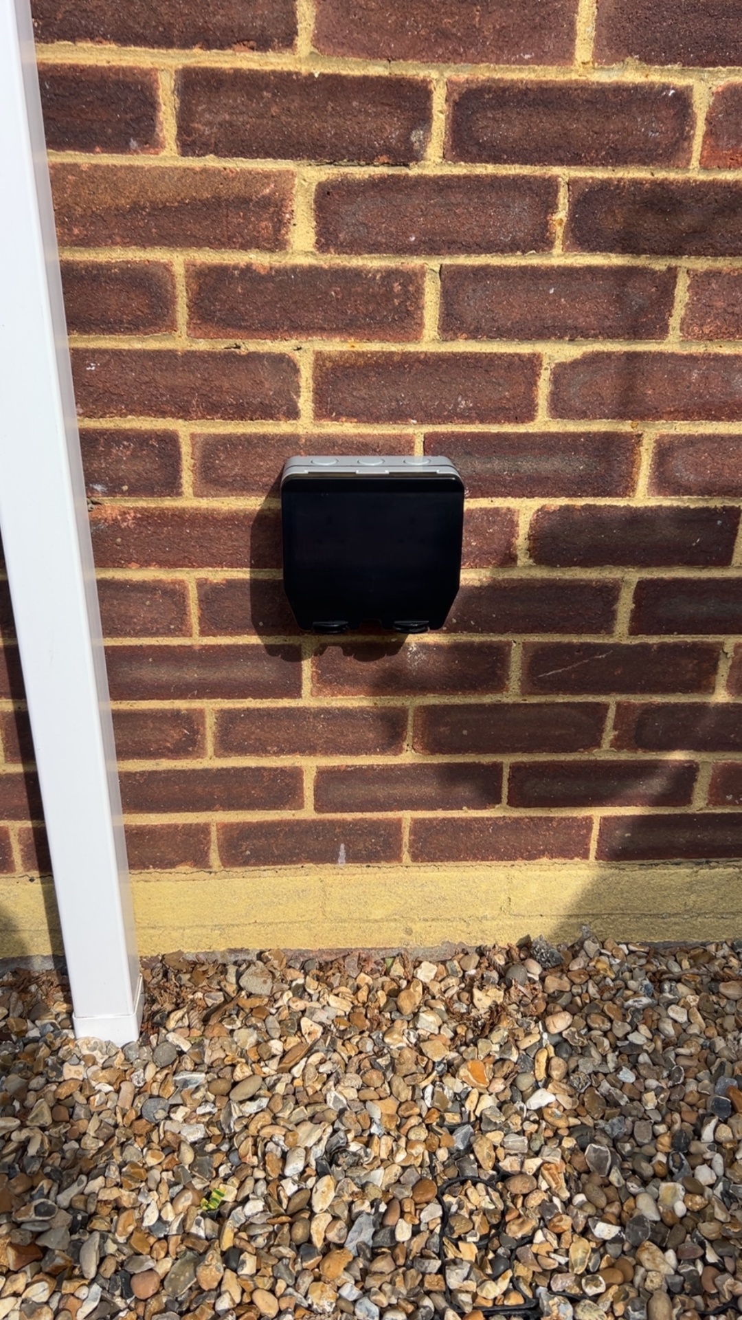 Weatherproof outdoor socket installed on brick wall