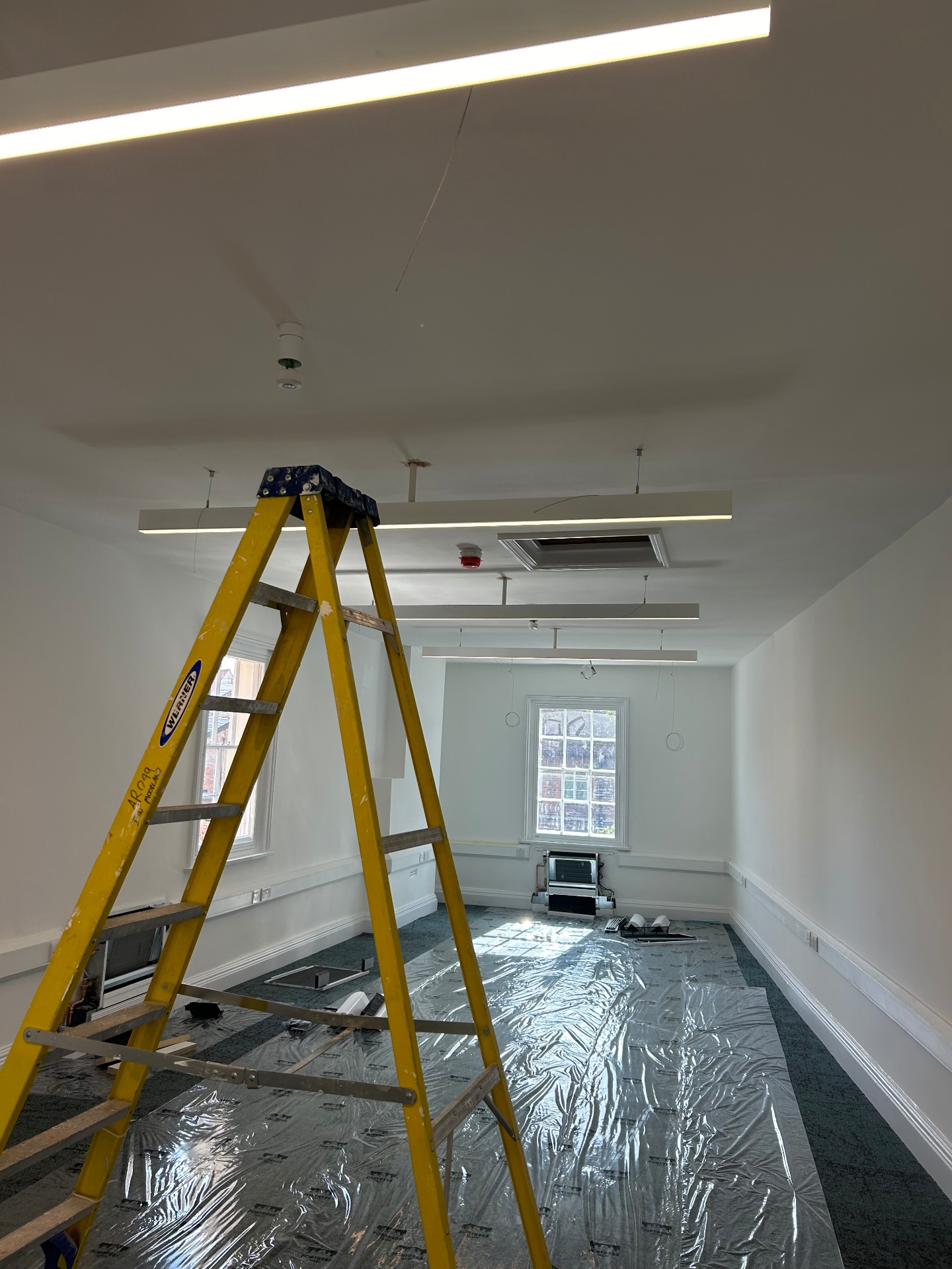 First fix rewiring in progress with fire alarm and ceiling cabling