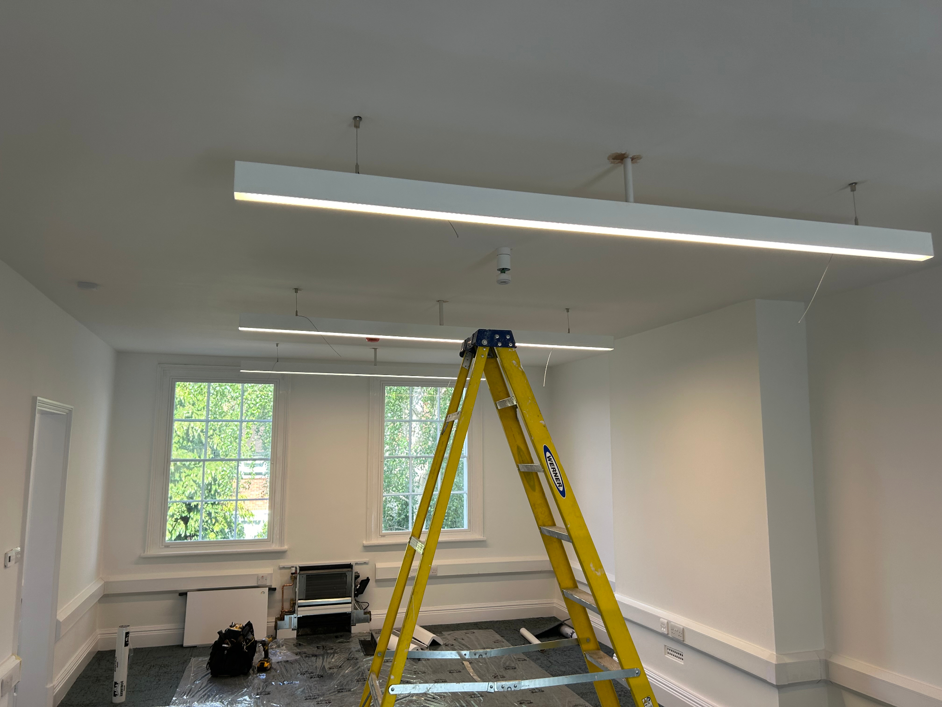 Rewiring in progress with new ceiling cables and smoke detector