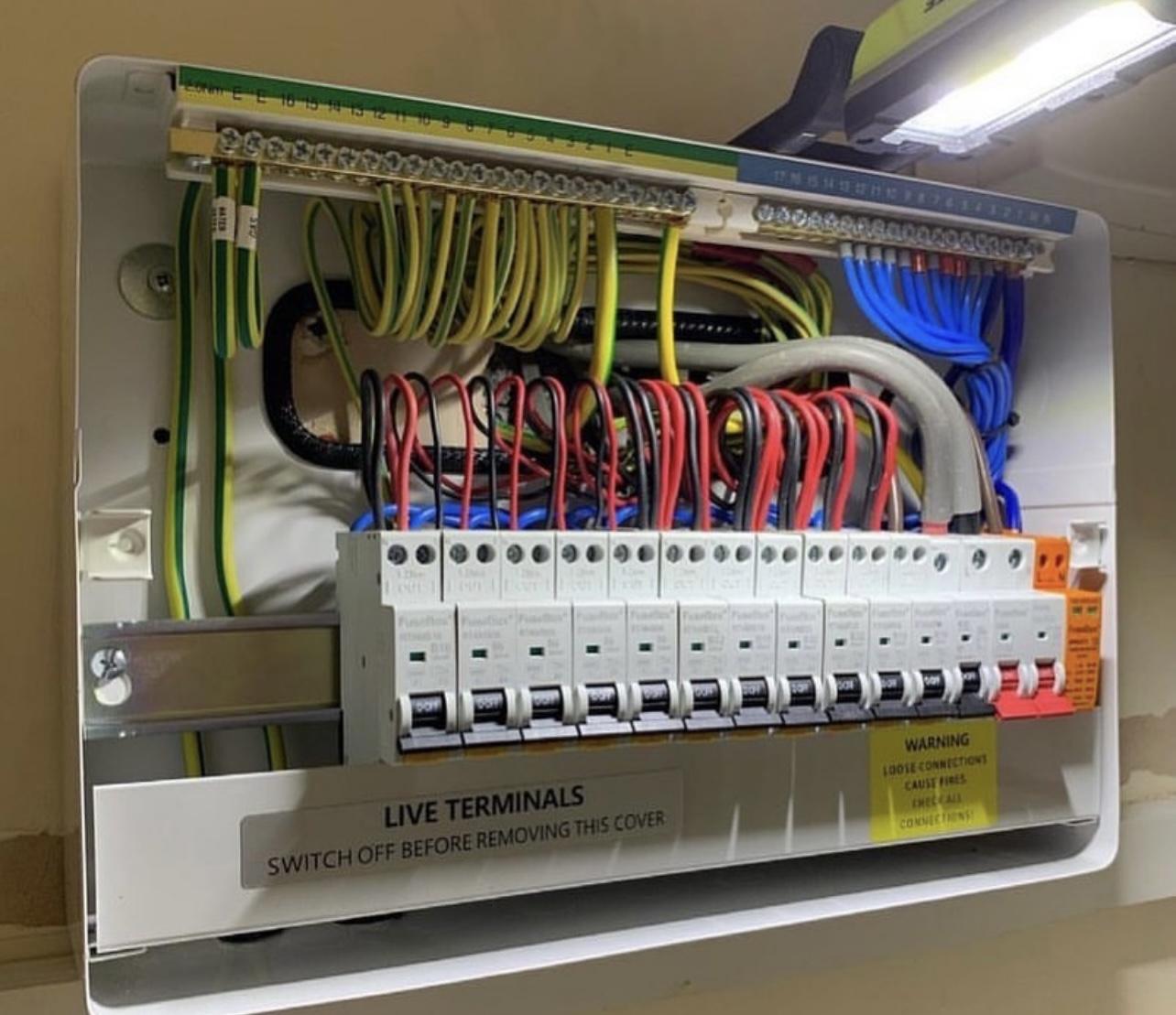 Consumer unit wiring with neatly routed cables and MCBs