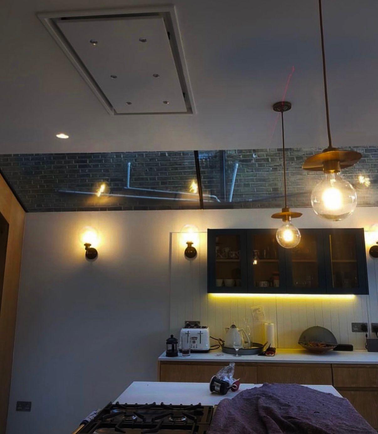 Globe wall light installation with exposed brick backdrop