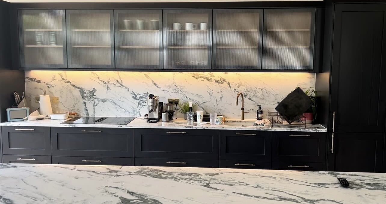 Kitchen with under-cabinet LED lighting and marble worktops